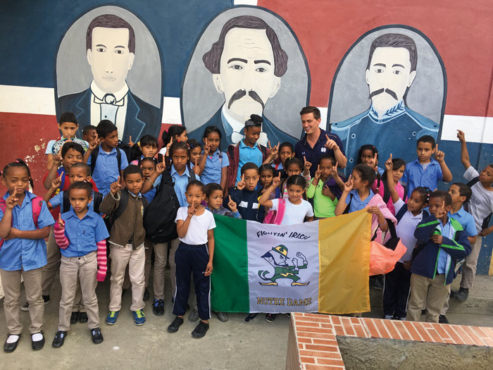 a group of children holding a fighting irish flag