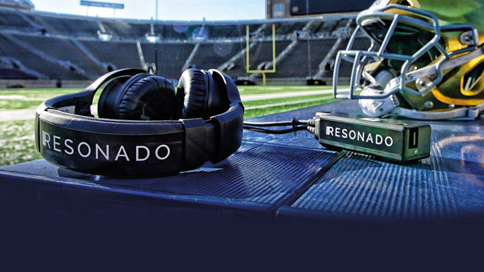 a resonado headset in the notre dame stadium next to a football helmet