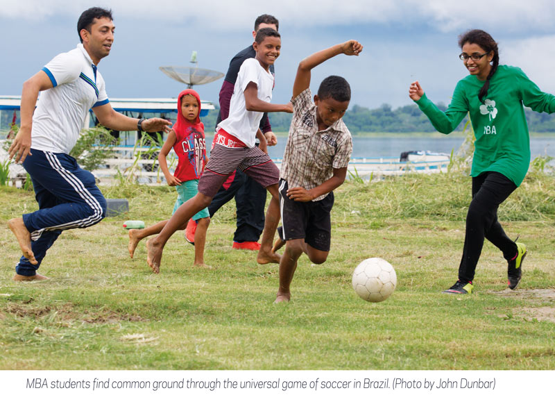 MBA students and kids in Brazil play soccer