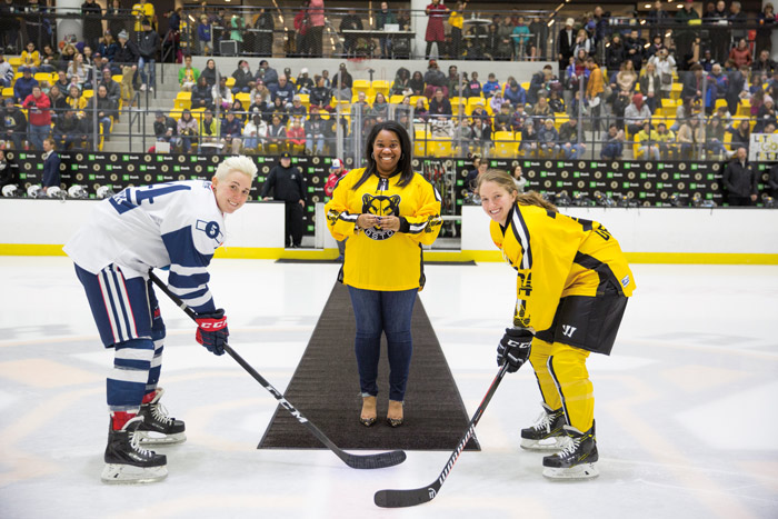 Stephanie Jackson and female hockey players in the rink