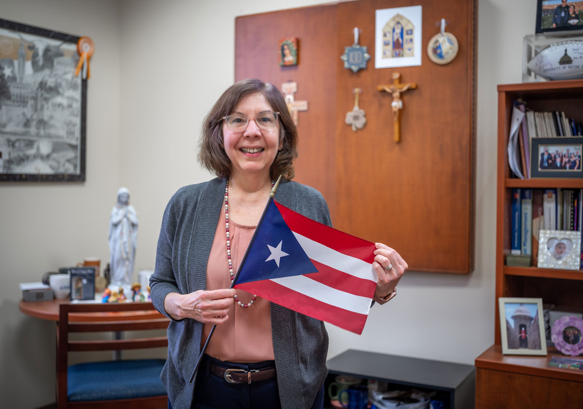 Sandra Vera Munoz standing with a Puerto Rican flag