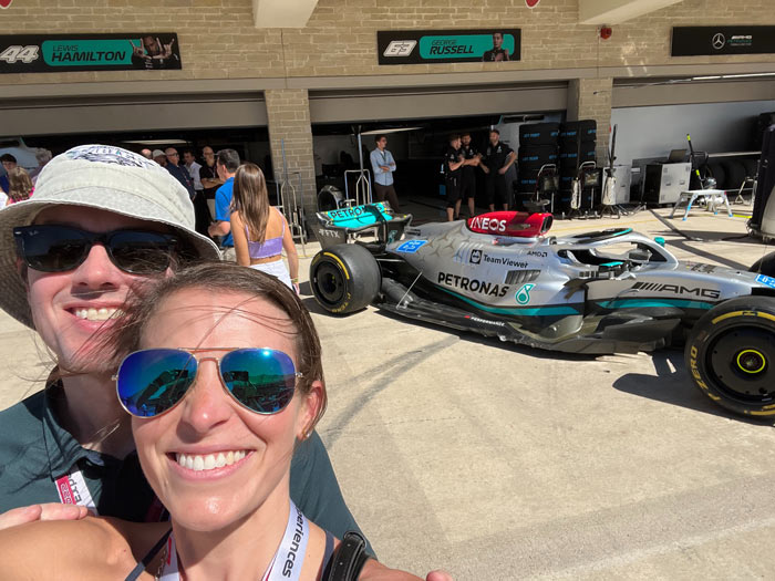 (Katie and husband Adam at the racetrack in front of the garages)