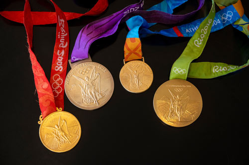 Tamika's gold medals on a black background