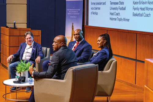 Panel members speak on the stage in the Jordan Auditorium