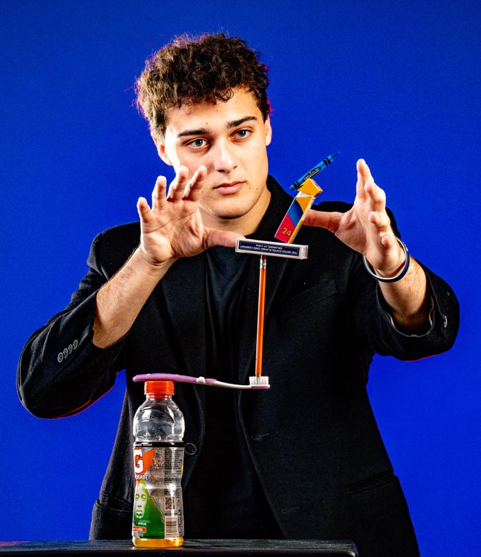 Jacob Baum balances a bunch of random items in a gravity-defying tower.
